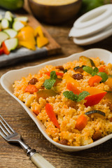 Millet with vegetables and raisins.