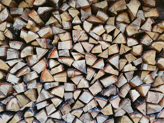 Firewood background, wall firewood, background of dry chopped firewood logs in a pile