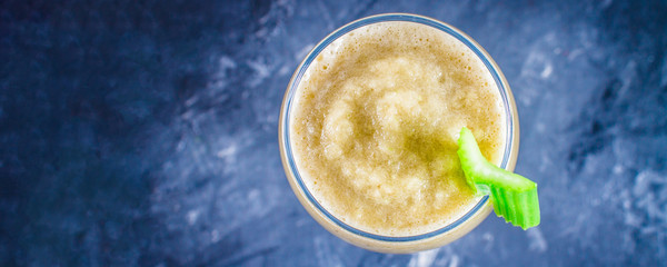 Top view. Green smoothie with celery, banana and apple