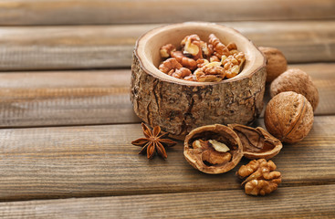 Bowl with walnut kernels on wooden table