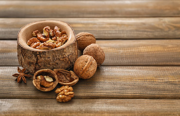 Bowl with walnut kernels on wooden table