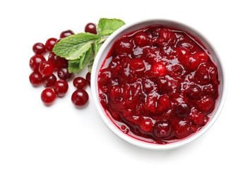 Bowl with tasty cranberry sauce on white background, top view