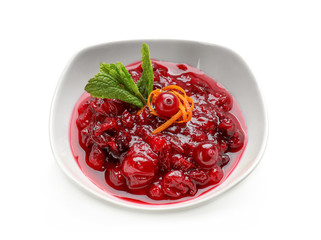 Bowl with tasty cranberry sauce and mint on white background