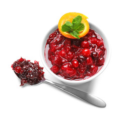 Bowl with tasty cranberry sauce, orange and mint on white background