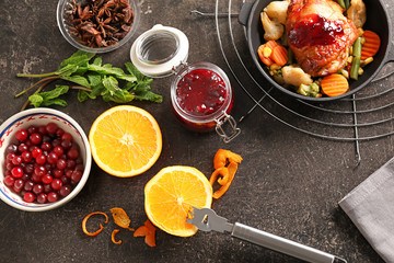 Flat lay composition with delicious cranberry sauce, fried chicken and ingredients on table