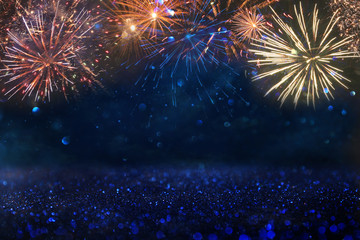 abstract gold, black and blue glitter background with fireworks. christmas eve, 4th of july holiday...