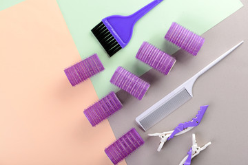 Flat lay composition with set of hairdresser's tools on color background