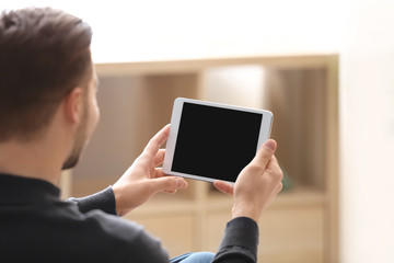 Young man using tablet at home