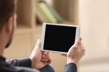 Young man using tablet at home