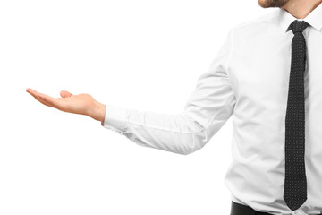 Young businessman holding something on white background