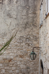 Lantern, white shutters and ivy on stone wall in Eze, France