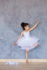 Fototapeta premium Little girl ballerina in a white tutu