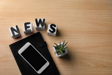 Composition with word NEWS on wooden background