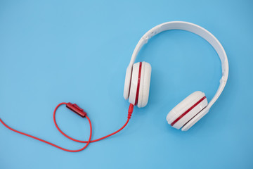 White headphones on blue background.