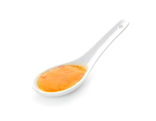 Spoon with tasty sauce on white background