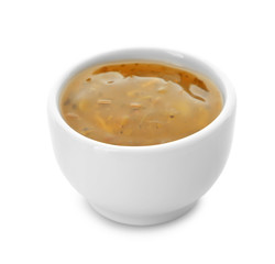 Tasty sauce with herbs in bowl on white background