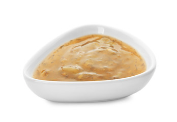 Tasty sauce with herbs in bowl on white background