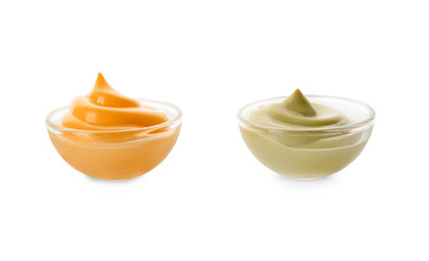 Two bowls with tasty sauces on white background