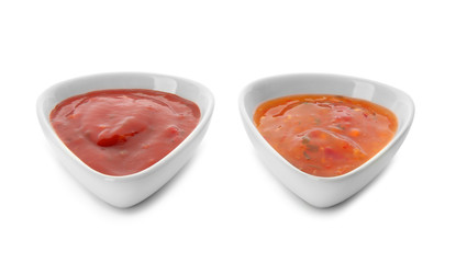 Two bowls with tasty sauces on white background