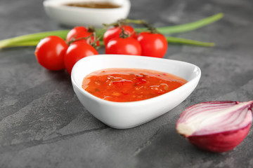 Bowl with tasty sauce on table