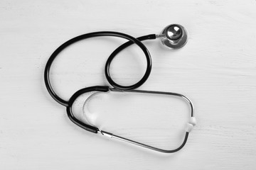 Stethoscope on white wooden background
