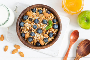 Homemade granola with nuts and berries in wooden bowl