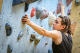 Teenage Boy Training On Climbing Wall