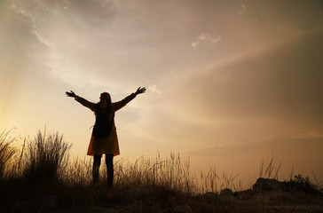 Silhouette of happy woman enjoying nature, enjoyment of nature and freedom