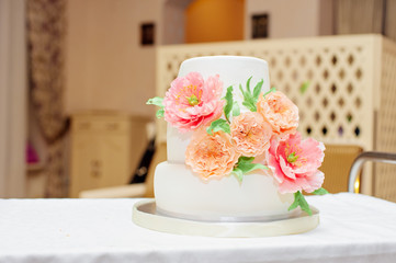 Big wedding cake decorated with flowers.
