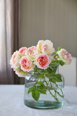 Beautiful bouquet of white and pink roses in the glass. Summer mood