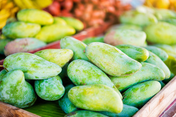 Green mango on the street market.