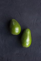 Avocado fruit on a black background