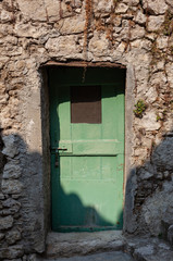 Old green door in Peillon, France