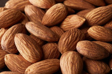 grain scattered handful of almonds close up