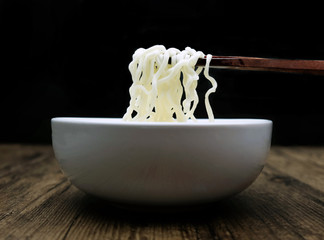 Close up of instant noodle in the glass bowl on black background.