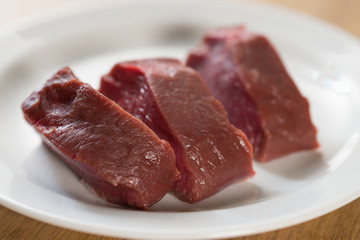 raw filet mignon steaks on white plate