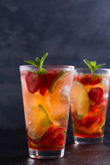 Strawberry mojito cocktail with berries, lime, mint and ice. Summer berry cocktail