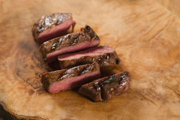 sliced medium filet mignon on wood board