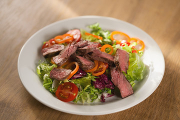 salad with sliced filet mignon steak