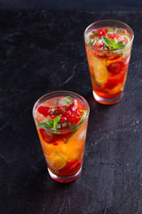 Strawberry mojito cocktail with berries, lime, mint and ice. Summer berry cocktail