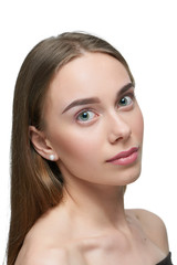 Obraz premium Studio portrait of a girl with light day make up looking at camera. model having beatiful face with nice straight eyebrows, plump lips, big eyes. Dark brown hair, opened shoulders. White background.