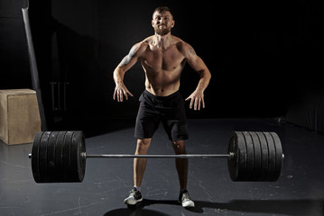 Man workout with barbell at gym