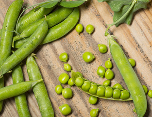 fresh green pea legumes on a wooden table