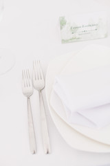 Details of a banquet table decor with napkin, cutlery and flowers