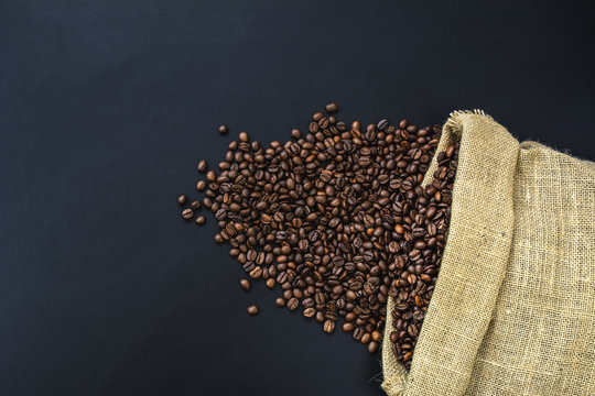 saco de arpillera con granos de cafe sobre pizarra 