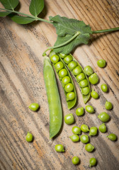 fresh green peas on a wood table close up