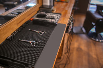 Professional scissors on table in hairdressing salon