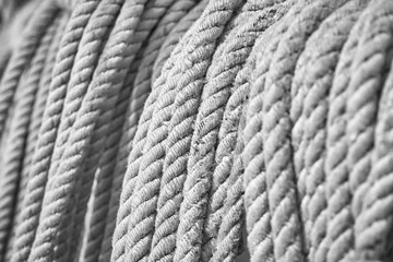 Black and white picture of old sailing boat ropes, selective focus, nautical background.