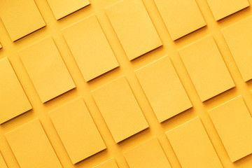 Mockup of horizontal golden business cards stacks arranged in rows at textured paper background. Top view