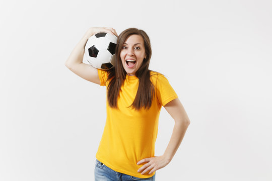 Happy European Young Woman, Football Fan Or Player In Yellow Uniform Holding Soccer Ball Support Favorite Team Isolated On White Background. Sport, Play Football, Cheer, Fans People Lifestyle Concept.